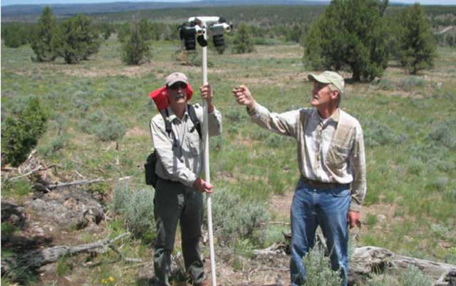 Art Talsma and a volunteer monitor the response of vegetation following juniper control.
