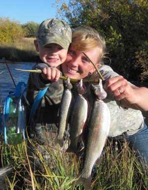 The Tyler family likes to fish and hunt, too. They catch lots of nice trout in the Lemhi River. Here, daughter Kristine catches fish with her son, Braxton.